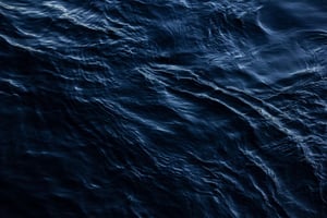 A mesmerizing view of the ocean's surface with dark ripples creating a dramatic effect.