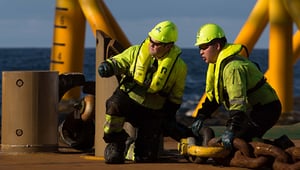 Crew members wearing protective gear during offshore deck operations